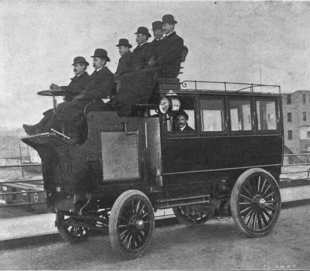 Motor bus with six men on the roof and one passenger inside